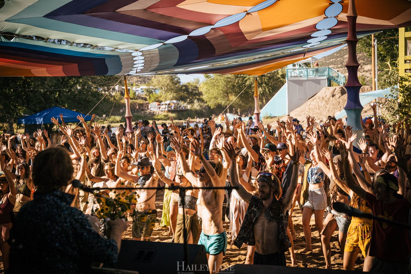 Crowd at Unison Festival with hands in the air, seen from the SANJI stage.